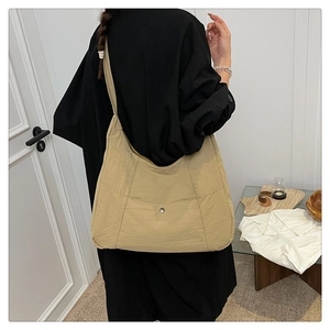 Spacious khaki nylon tote bag for women showing back view size and carrying style