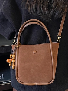 Large brown faux suede bucket bag with wooden beads and adjustable shoulder strap