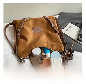 Top view of spacious brown suede tote showing interior capacity with daily essentials