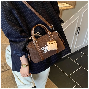 Detail of vintage brown leopard print Boston bag with embroidery and plush charm
