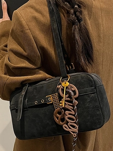 Vintage black faux suede underarm tote bag with metallic hardware and decorative charms