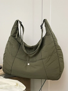 Minimalist olive green quilted nylon tote bag with adjustable shoulder strap and snap pocket