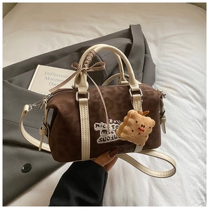 Detail of vintage leopard print Boston bag with embroidery and plush biscuit pendant