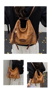 Detail showing the brown suede texture, leather logo patch and tassels on this tote bag