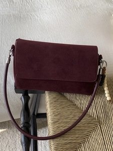 Minimalist burgundy suede shoulder bag with decorative wooden beads in a retro style