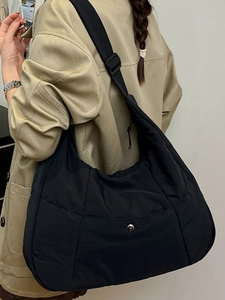 Black nylon tote crossbody bag for women with adjustable strap and quilted detail