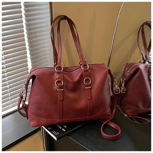 Bordeaux red tote bag detail showing matte pebble leather and silver metal ring hardware