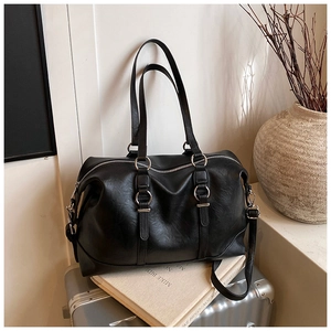 Close-up of black PU leather tote bag texture with silver hardware on a vintage background