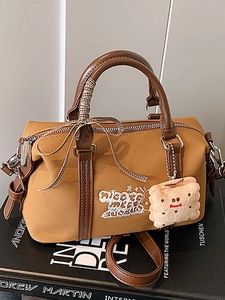 Retro mustard yellow Boston bag with brown leather straps and embroidery details