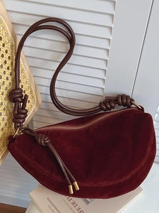 Minimalist burgundy suede moon-shaped crossbody bag with knotted brown leather strap