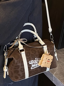 Vintage leopard print Boston bag with white leather handles and a cookie plush charm