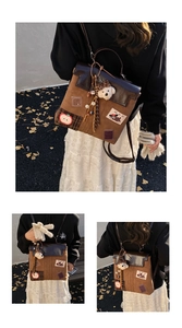 Detailed close-up of retro brown patchwork backpack with plush bear and cartoon patches