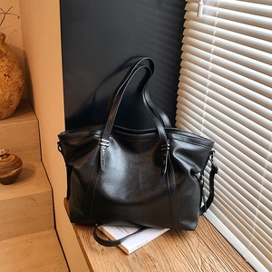 Minimalist black faux leather large tote bag with dual straps and soft texture
