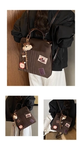 Detail view of retro brown backpack with MDD embroidery patches and cute bear plush charm