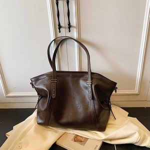Dark brown large tote bag with star rivets and vintage leather texture for women