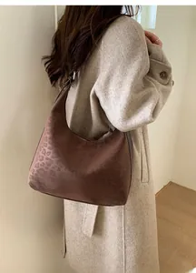 Brown leopard print hobo bag worn over the shoulder showing vintage casual style