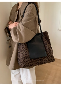 Detail of leopard print tote bag with leather pocket and long shoulder straps