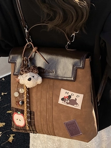 Retro preppy style dark brown leather backpack with cartoon patches and plush dog charm