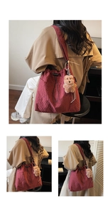 Detail of red checkered canvas tote with drawstring closure and cute teddy bear charm