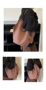 Detail of dark brown suede tote bag with fine stitching and magnetic charm