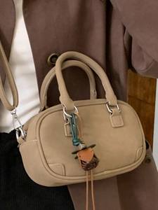 Retro khaki Boston handbag with adjustable strap and decorative woven pendant for women