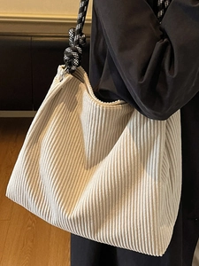 Minimalist beige corduroy tote bag with black and white checkered woven shoulder strap