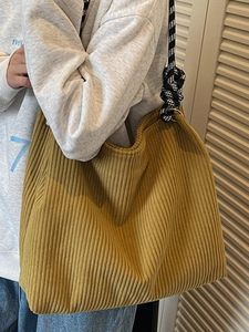 Minimalist corduroy tote bag in mustard yellow with checkered woven shoulder strap
