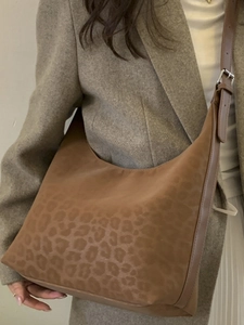 Retro leopard print tote bag with adjustable brown strap shown as stylish shoulder bag