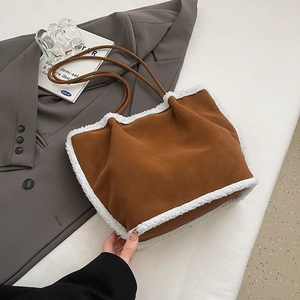 Detail der karamellbraunen Wildleder-Tote Bag mit weißem Lammfellbesatz und Lederriemen