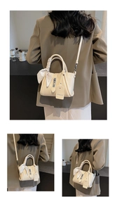 Detailed close-up of a beige leather bucket bag featuring a decorative silk scarf on the handle