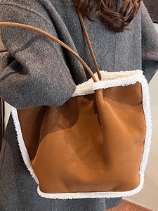 Braune Wildleder-Einkaufstasche mit weißem Kunstpelzbesatz an einem Model getragen