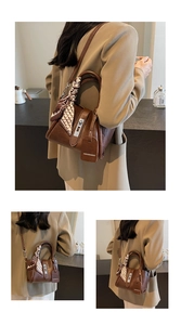 Detail of vintage brown leather bag with geometric silk scarf and fashion tag