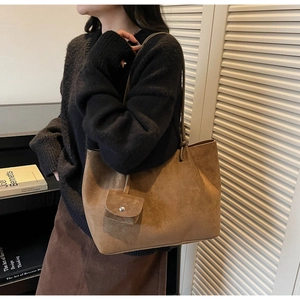 Detail of dark camel faux suede tote bag with small snap pouch and slim shoulder straps
