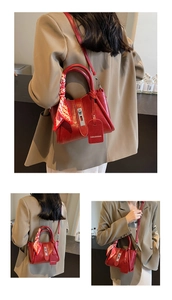 Detail of red textured leather bucket bag featuring a decorative checkered silk scarf