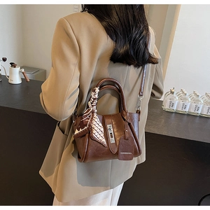 Detailed back view of a brown leather bucket bag with silk scarf and fashion tag