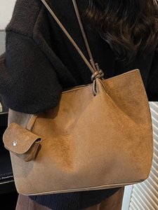 Brown faux suede large tote bag with shoulder straps and decorative knot detail