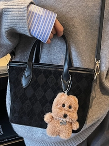 Vintage black tote bucket bag with quilted patterns and brown plush dog pendant for women