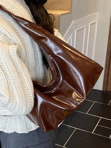 Retro deep brown glossy leather shoulder bag with a minimalist triangular tote design