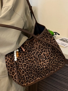 Retro leopard print tote bag with brown leather trim and beaded charm pendant