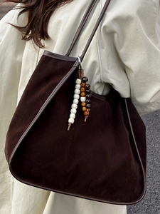 Retro dark brown faux suede tote bag with stylish beaded charms and leather trim on model