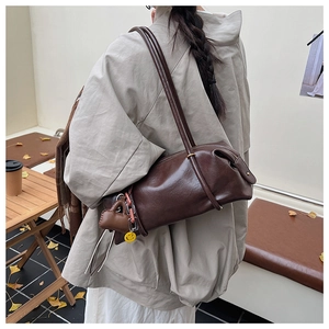 Retro brown leather cylindrical bag with heart pendant and smiley face charm detail