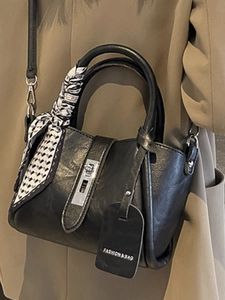 Black PU leather bucket bag with scarf-wrapped handle and silver metal turn-lock
