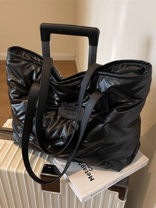 Fashionable black puffer tote bag with quilted nylon texture and large capacity for travel
