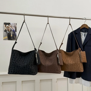 Three leopard print tote bags in charcoal, coffee, and tan with matching coin purses