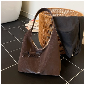 Detail view of dark brown Hobo tote bag with detachable eyewear holder accessory