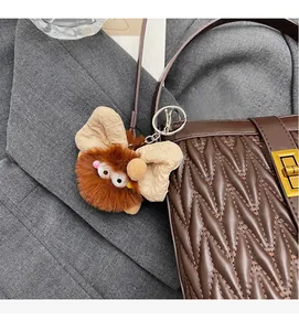 Ciondolo per borsa mostro marrone in peluche con grandi occhi e clip in metallo argento