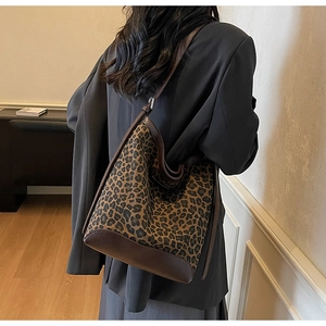 Detailed back view of a leopard print hobo bucket bag with brown leather trim details