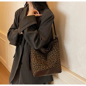 Detail of the large leopard print bucket bag showing high capacity and side view on shoulder