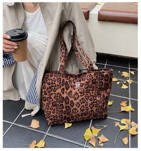 Detail of leopard print canvas tote bag featuring a cute cartoon bear embroidery