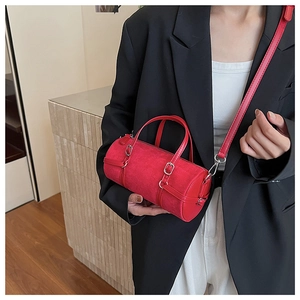 Detail of red bowling bag showing smooth faux leather texture and silver metal hardware